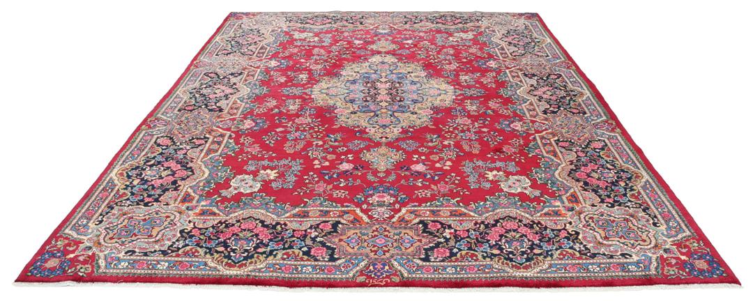 A hand-knotted Mashad rug from the Middle East in dark-red and blue tones.