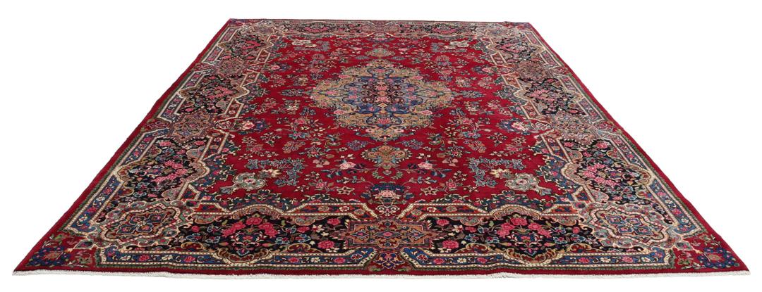 A hand-knotted Mashad rug from the Middle East in dark-red and blue tones.