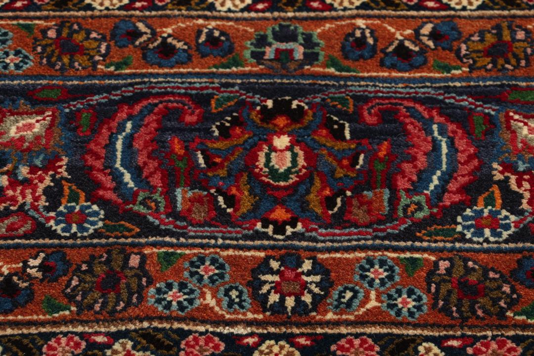 Håndknyttet Mashad-tæppe fra Mellemøsten i levende røde og blå nuancer