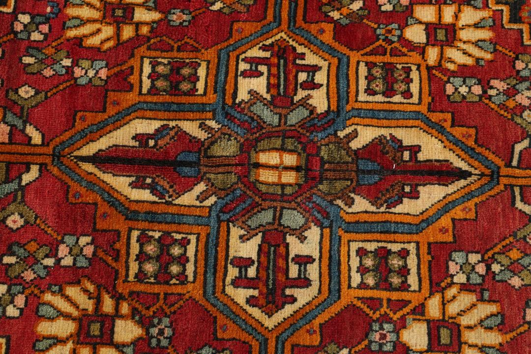 Een handgeknoopt Khashkuli-tapijt uit het Midden-Oosten met een donkerrood en blauw geometrisch ontwerp.