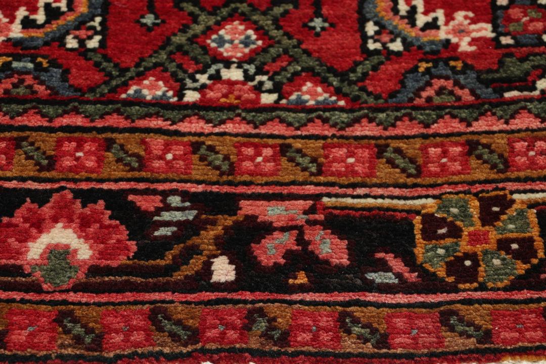 Hand-knotted Hosseinabad runner in red from the Middle East