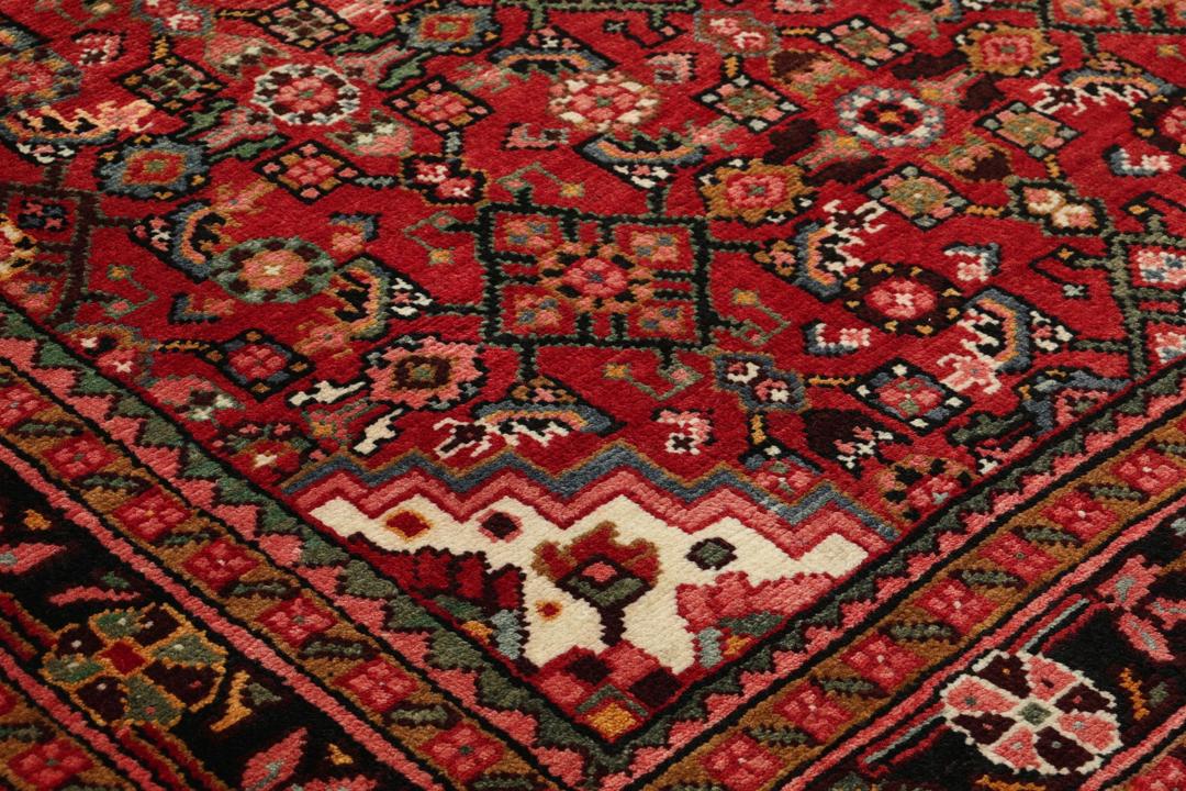 Hand-knotted Hosseinabad runner in red from the Middle East