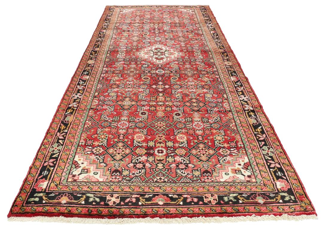 Hand-knotted Hosseinabad runner in red from the Middle East