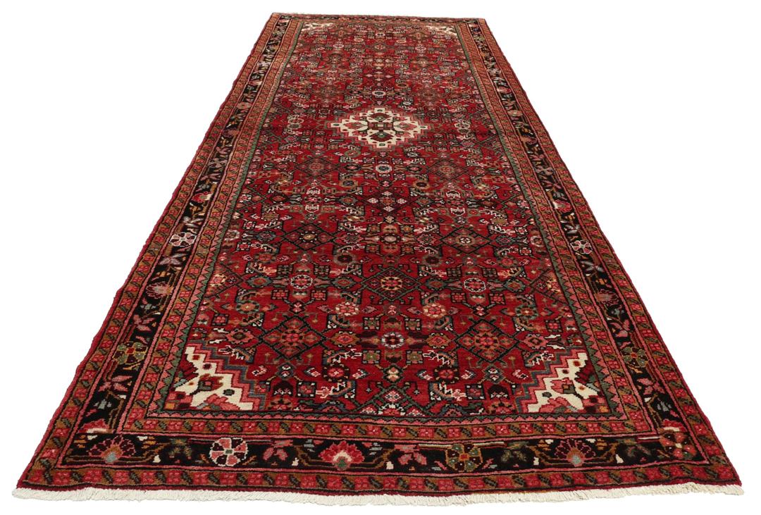 Hand-knotted Hosseinabad runner in red from the Middle East