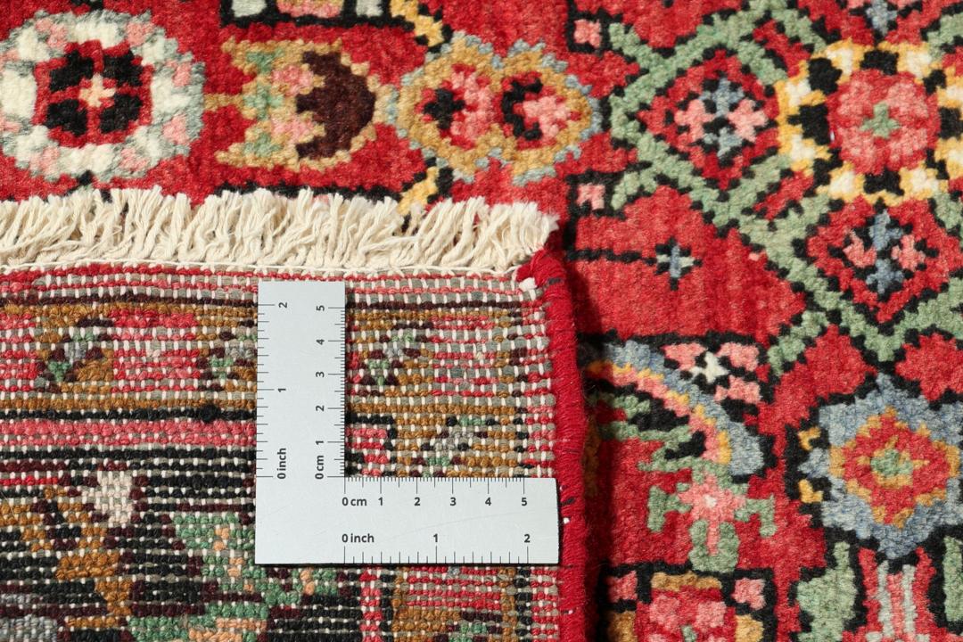 Hand-knotted Hosseinabad runner in red from the Middle East