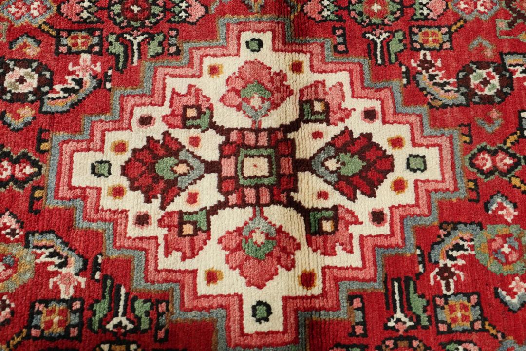 Hand-knotted Hosseinabad runner in red from the Middle East
