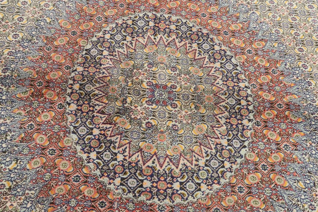 Hand-knotted Moud rug from the Middle East featuring a multicolor floral medallion design.