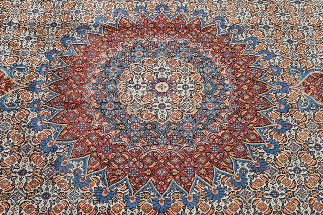 A hand-knotted Moud rug from the Middle East with a detailed medallion in multicolor.
