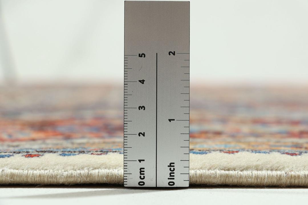 A hand-knotted Moud rug from the Middle East with a detailed medallion in multicolor.