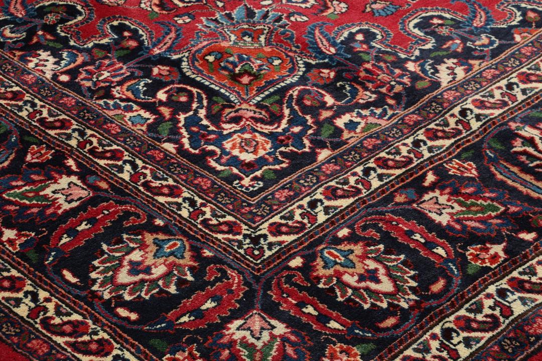 Hand-knotted Mashad rug from the Middle East in deep red and dark blue tones
