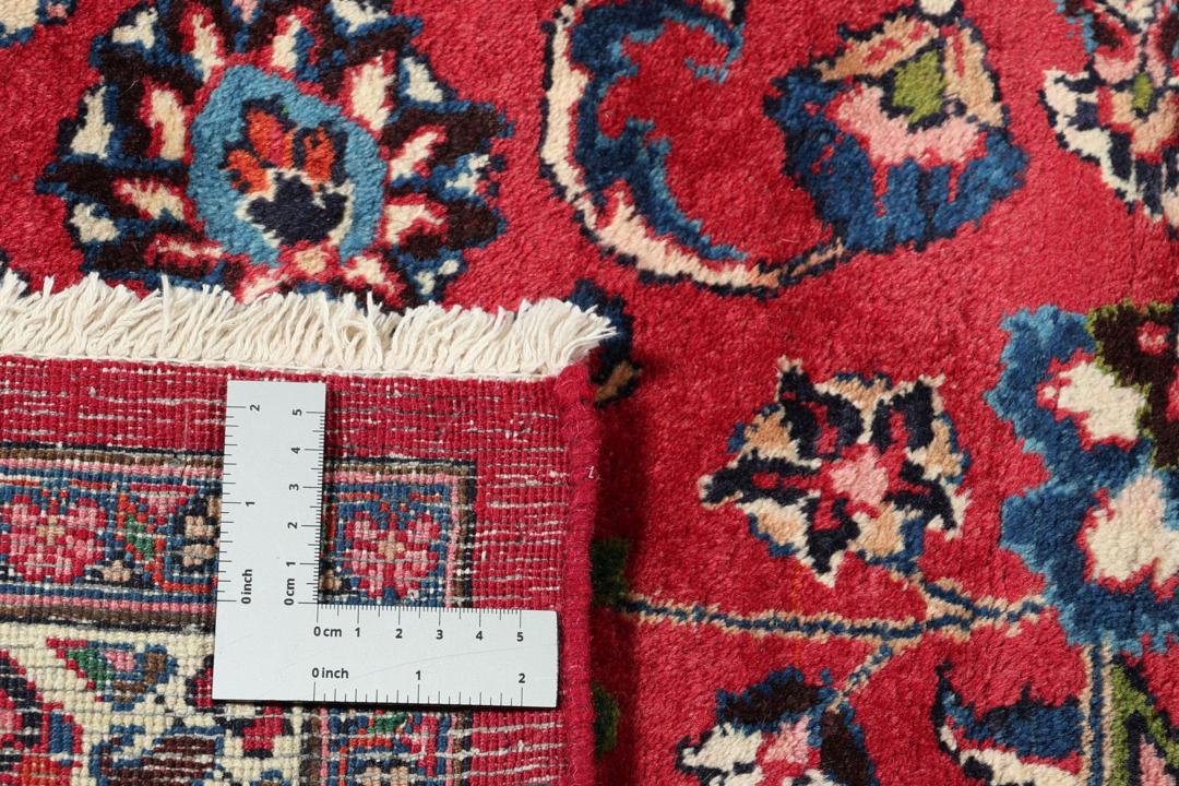 Hand-knotted Mashad rug from the Middle East in deep red and dark blue tones