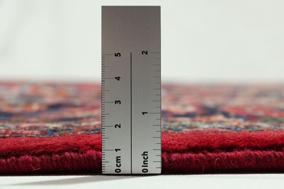 Hand-knotted Mashad rug from the Middle East in deep red and dark blue tones