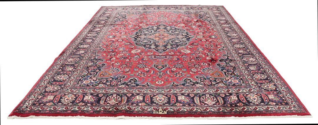 Hand-knotted Mashad rug from the Middle East in deep red and dark blue tones