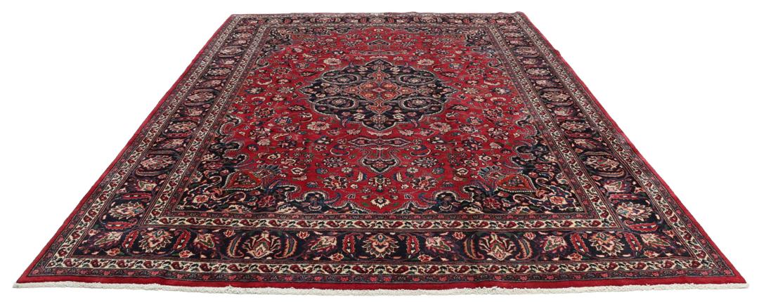 Hand-knotted Mashad rug from the Middle East in deep red and dark blue tones