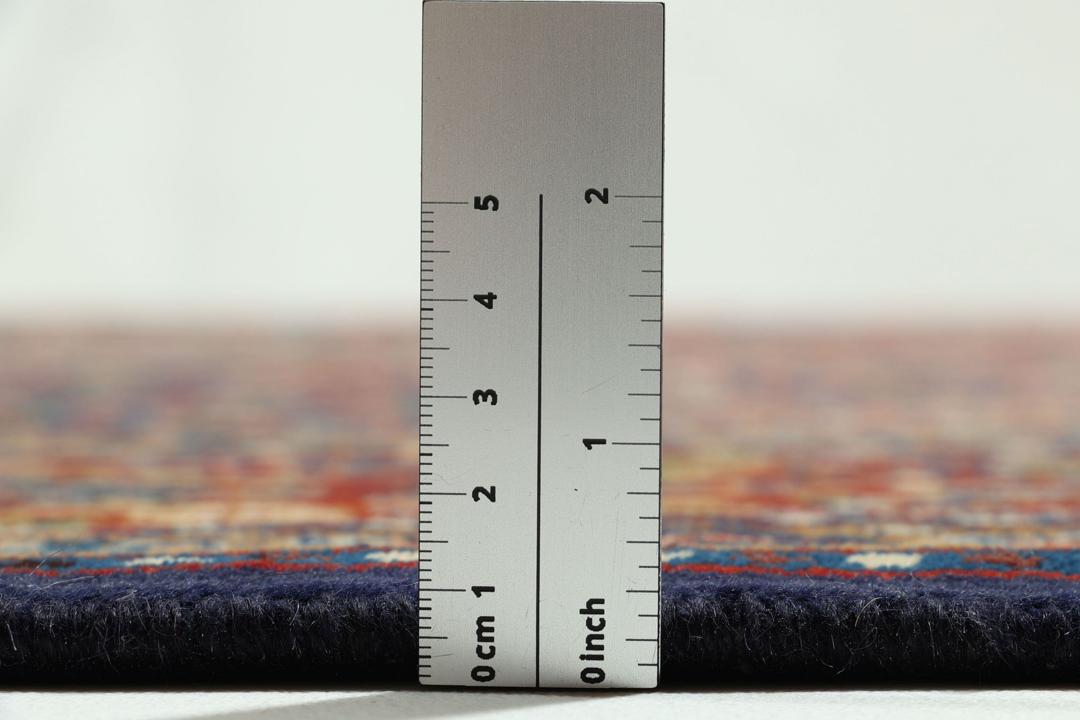 A hand-knotted Moud rug from the Middle East in dark-red and dark-blue tones.