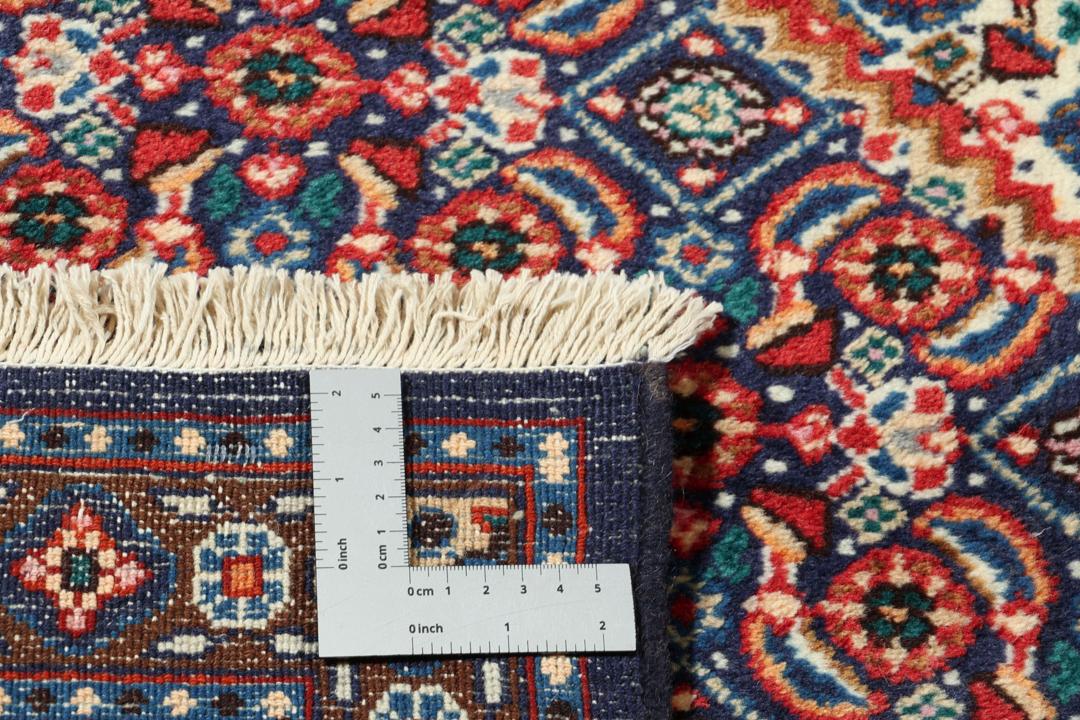 A hand-knotted Moud rug from the Middle East in dark-red and dark-blue tones.