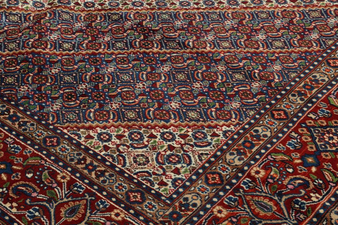 A hand-knotted Moud rug from the Middle East in dark-red and dark-blue tones.