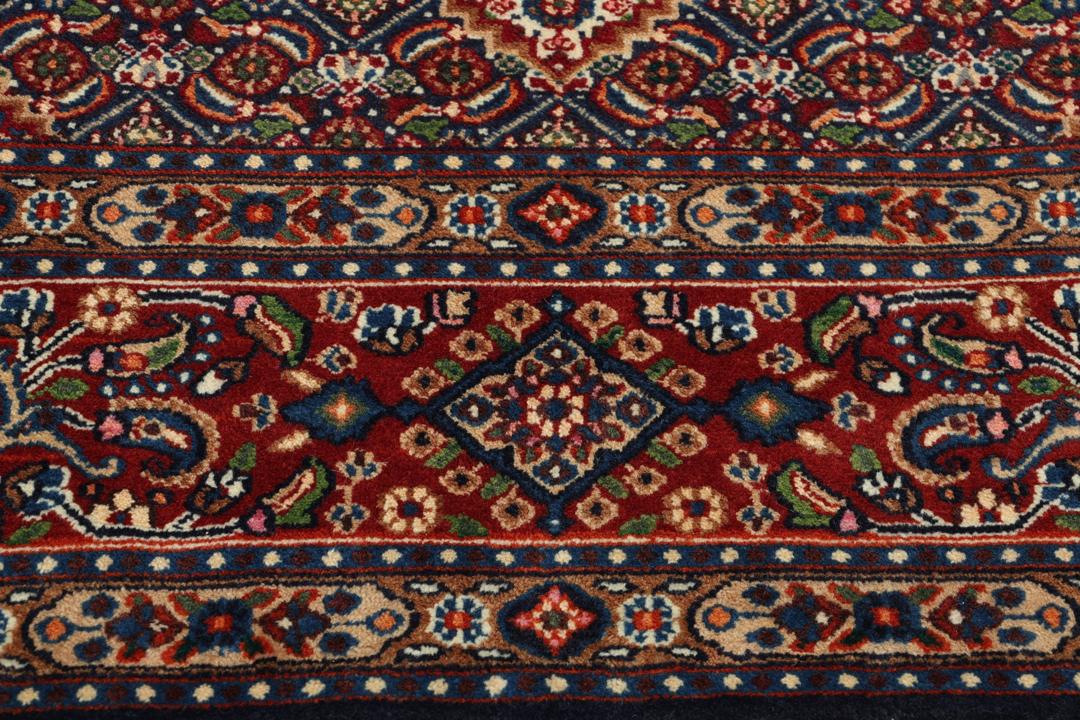 A hand-knotted Moud rug from the Middle East in dark-red and dark-blue tones.