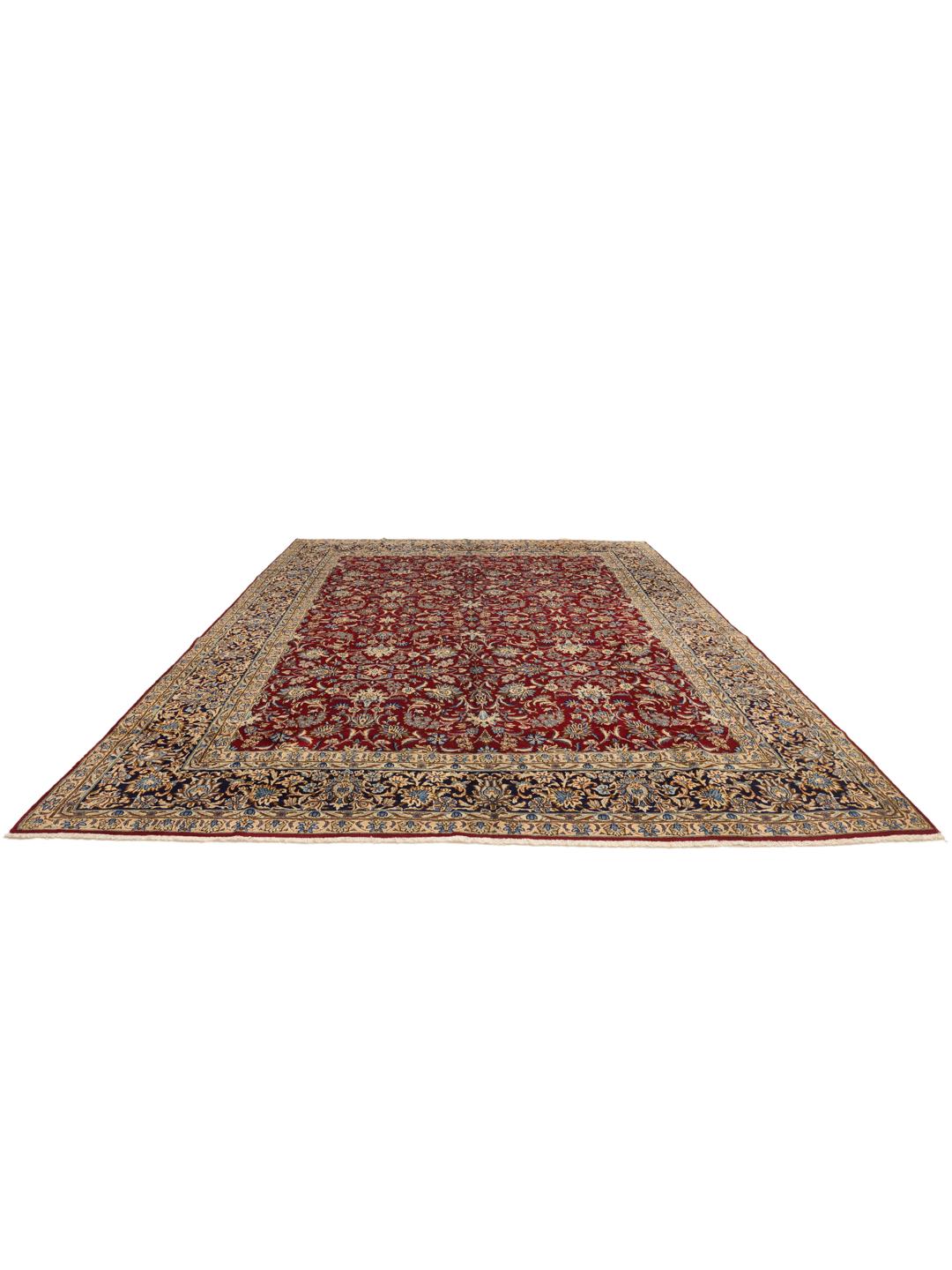 A hand-knotted Kerman rug from the Middle East featuring a vibrant red field and intricate floral patterns.
