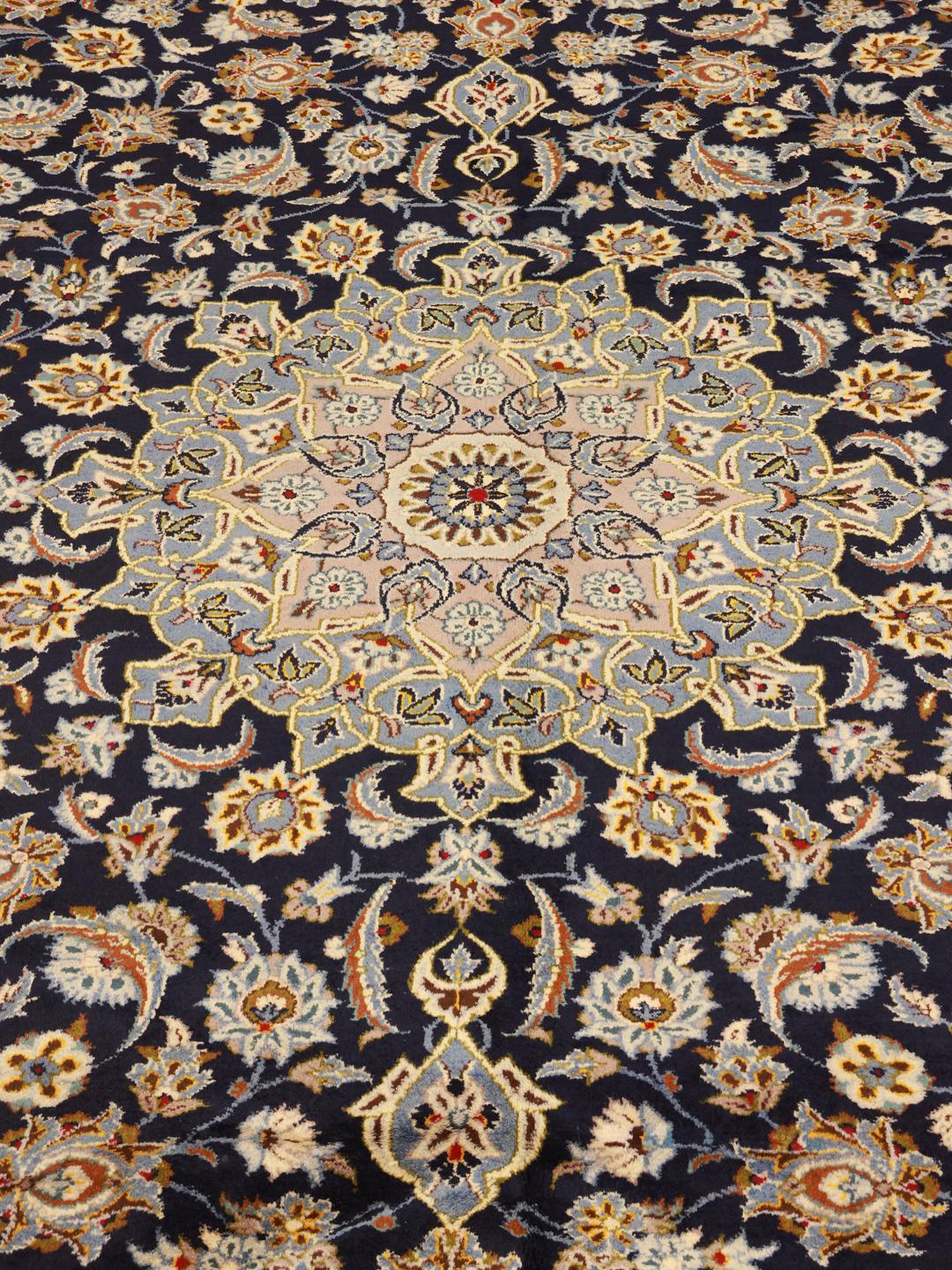 Hand-knotted Keshan rug from the Middle East in dark-blue with a floral medallion pattern.
