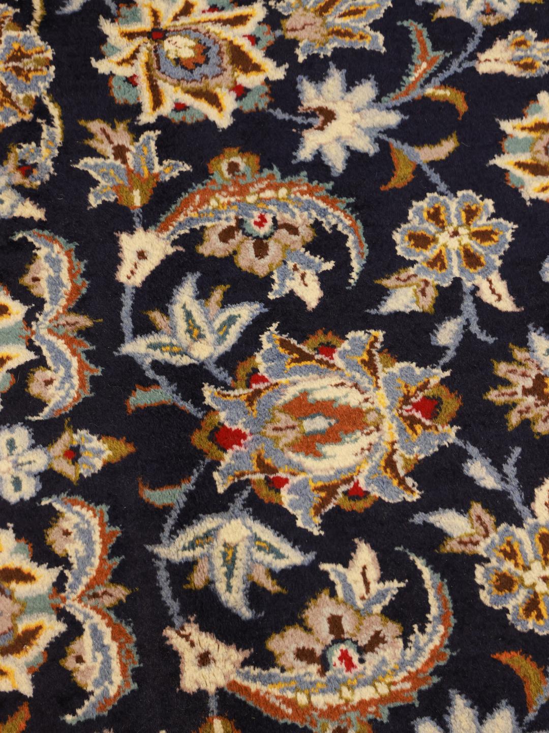 Hand-knotted Keshan rug from the Middle East in dark-blue with a floral medallion pattern.