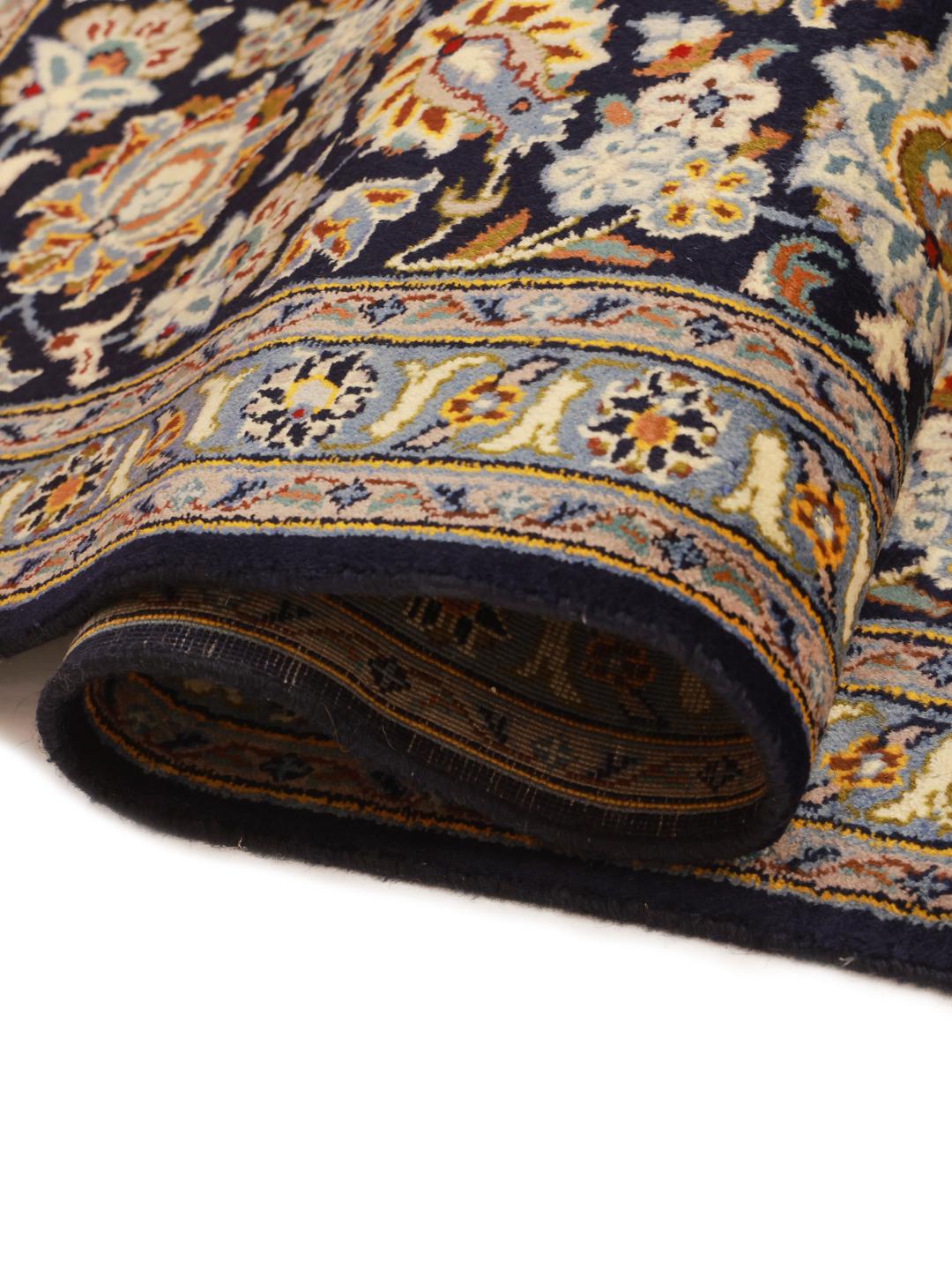 Hand-knotted Keshan rug from the Middle East in dark-blue with a floral medallion pattern.