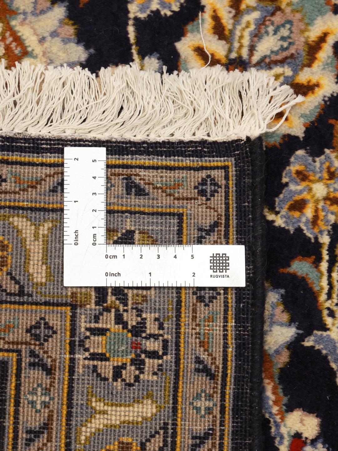 Hand-knotted Keshan rug from the Middle East in dark-blue with a floral medallion pattern.