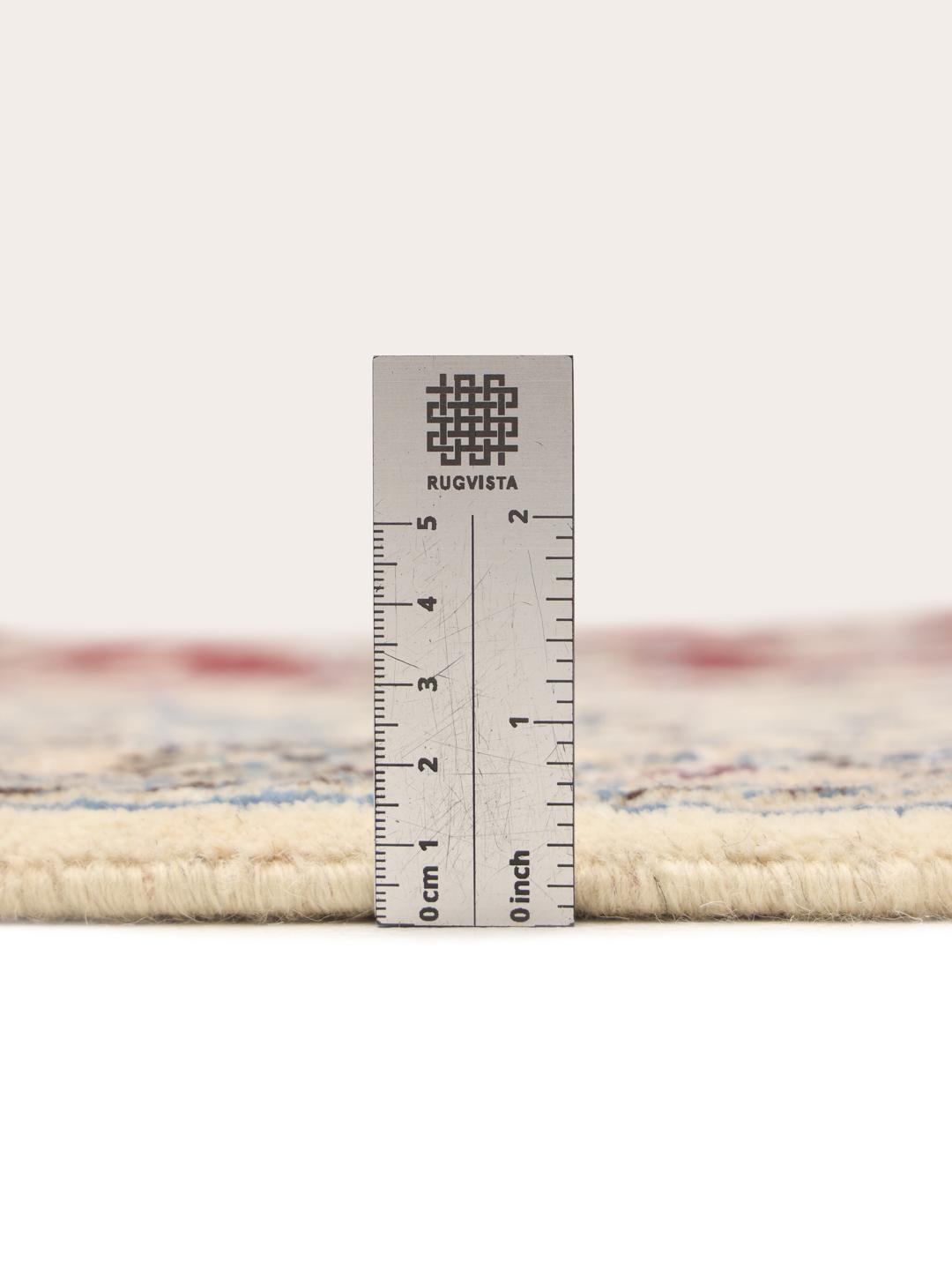 Hand-knotted Nain rug from the Middle East featuring a dark-red floral field and blue border
