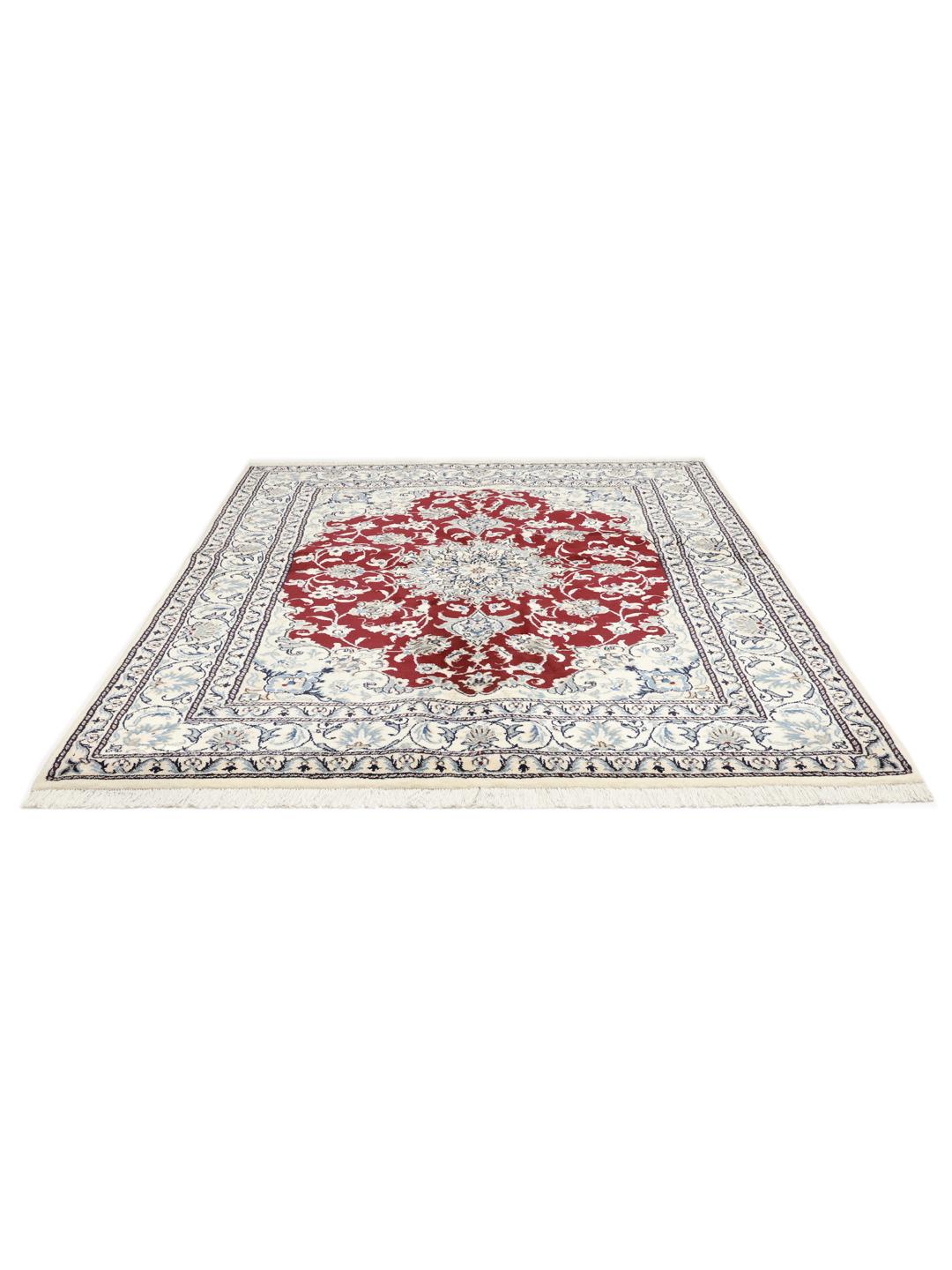 Hand-knotted Nain rug from the Middle East featuring a dark-red and blue floral medallion design.