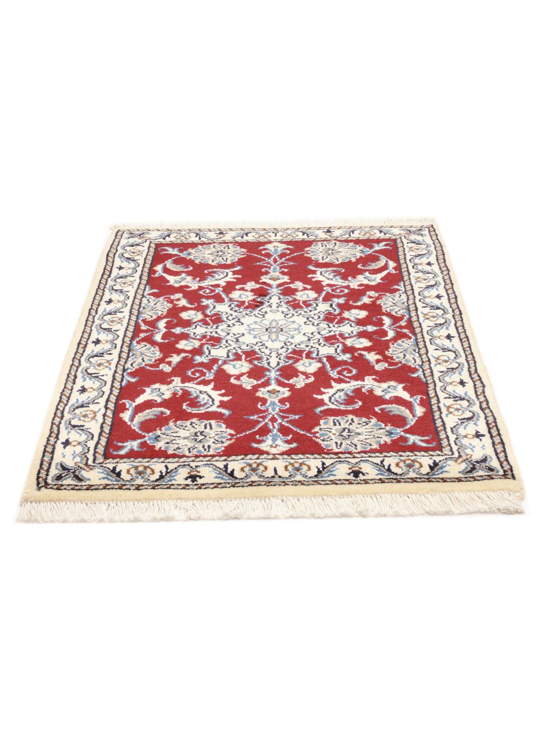 Hand-knotted Nain rug from the Middle East in dark-red with floral motifs.