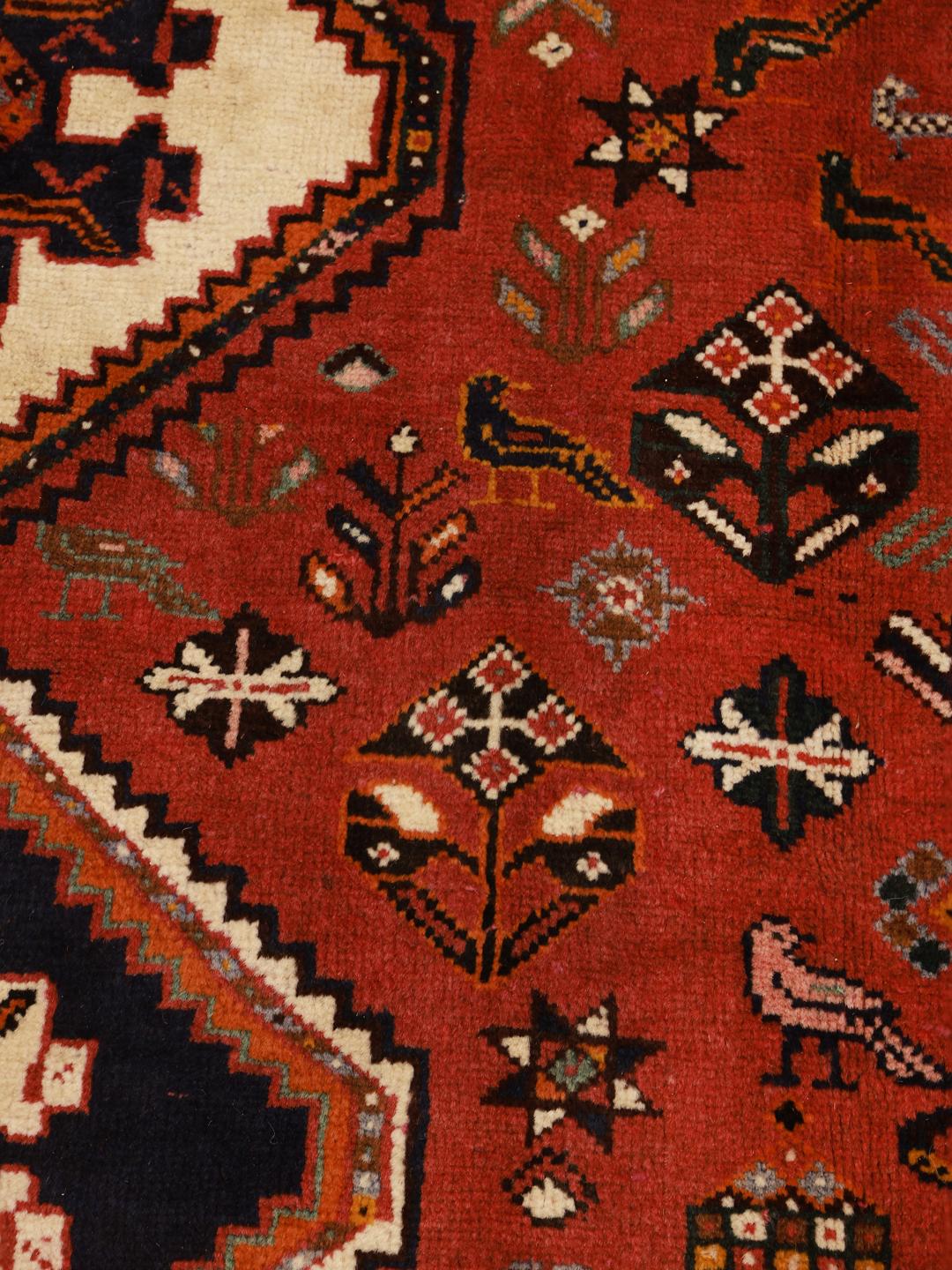 Hand-knotted Shiraz rug from the Middle East in deep red and blue tones
