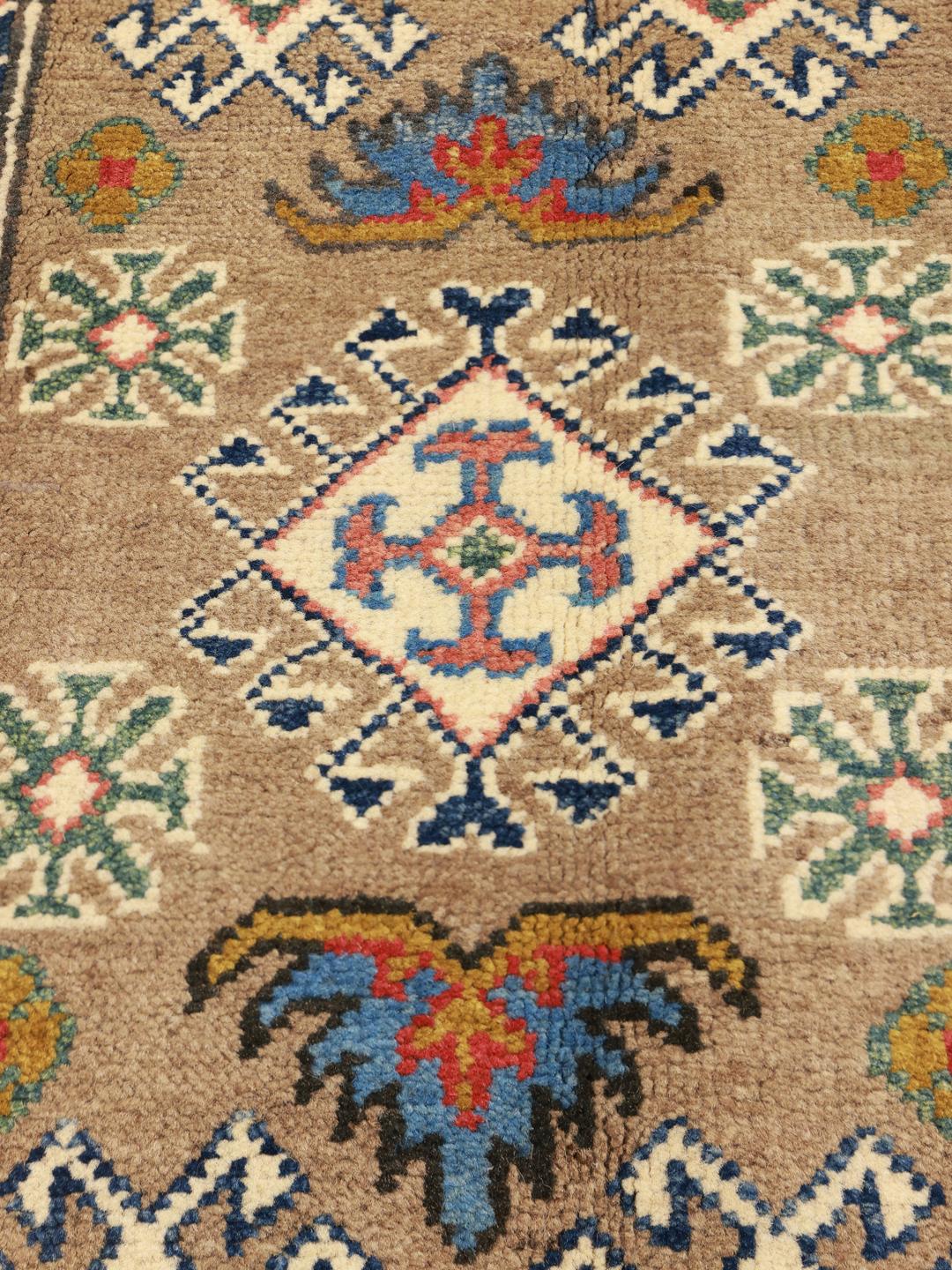 Handgeknoopt Kazak-tapijt uit Afghanistan met bruine, rode en blauwe geometrische motieven.
