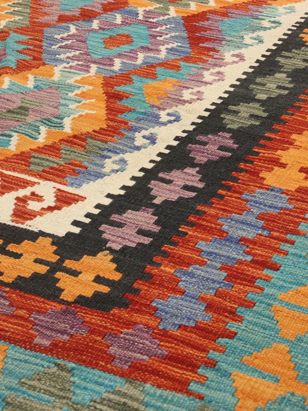 Hand-woven Afghan Kelim rug with a vibrant multicolor diamond pattern