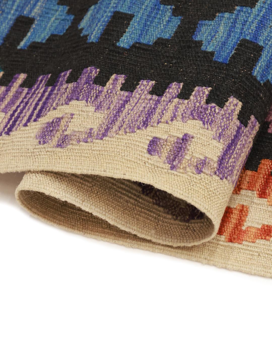 A large rectangular hand-woven Afghan Kelim rug featuring a vibrant multicolor geometric diamond pattern.
