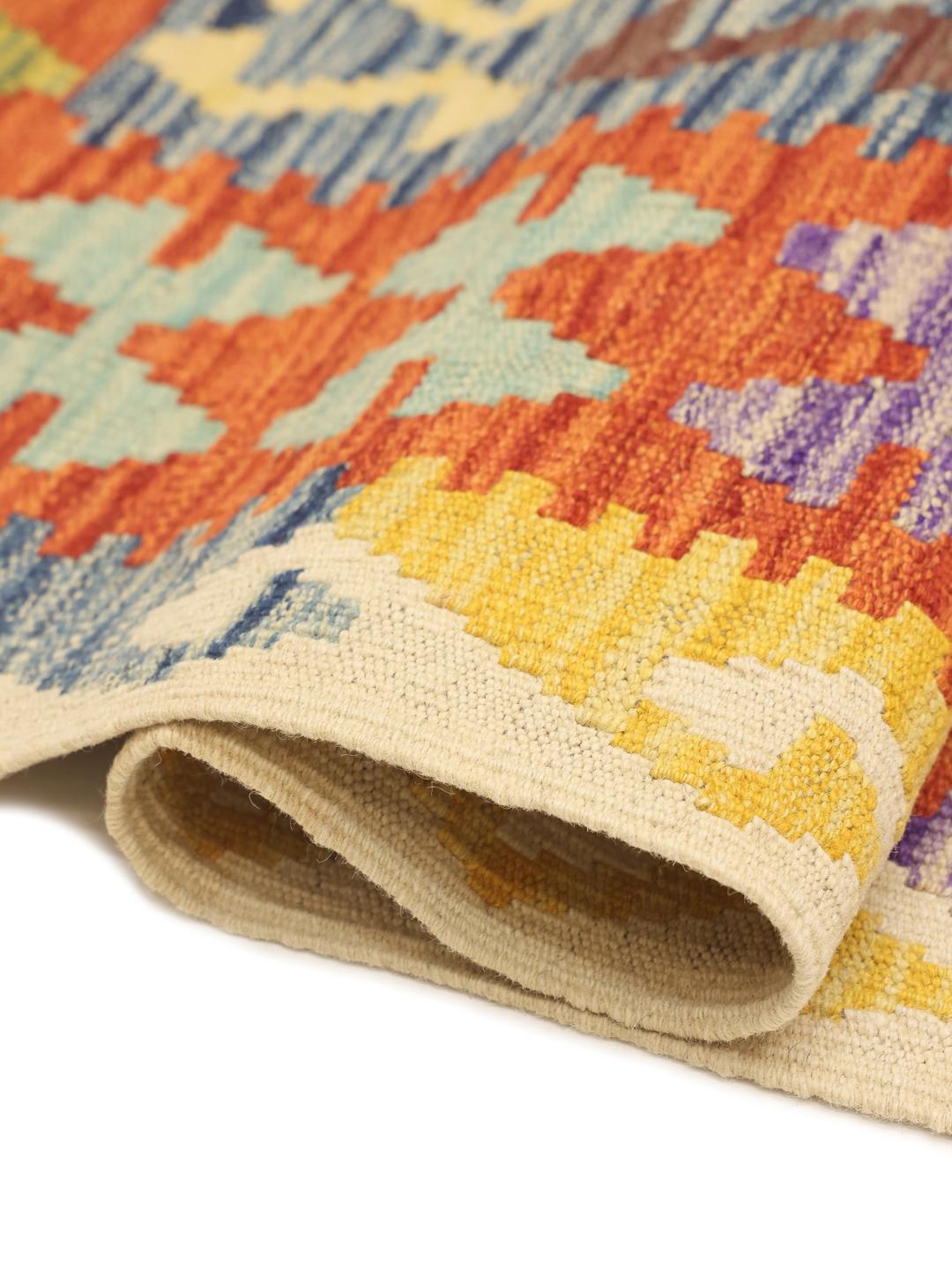 A large, rectangular hand-woven Afghan Kelim rug featuring a vibrant, multi-coloured diamond pattern.