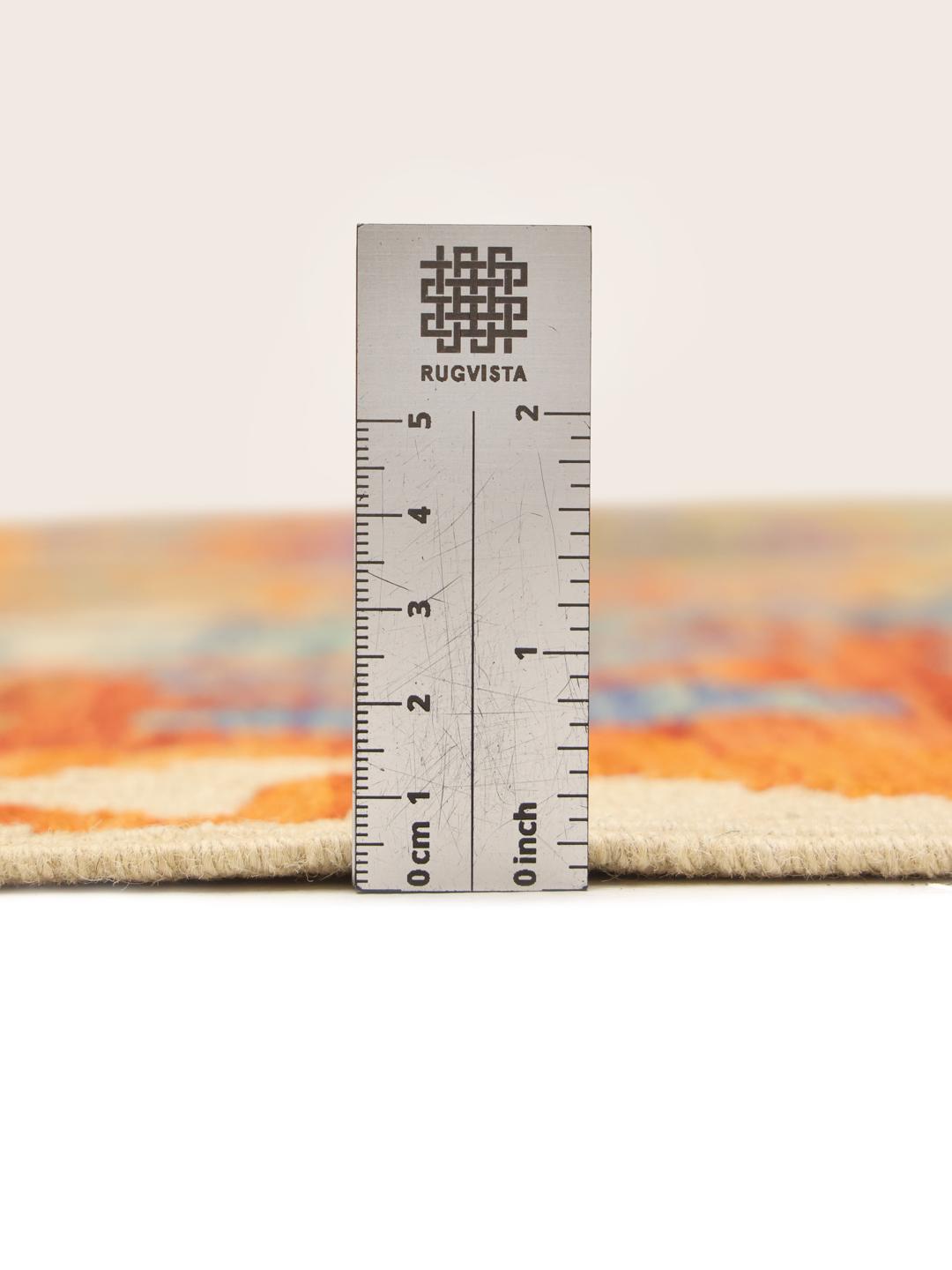 A large, rectangular hand-woven Afghan Kelim rug featuring a vibrant, multi-coloured diamond pattern.