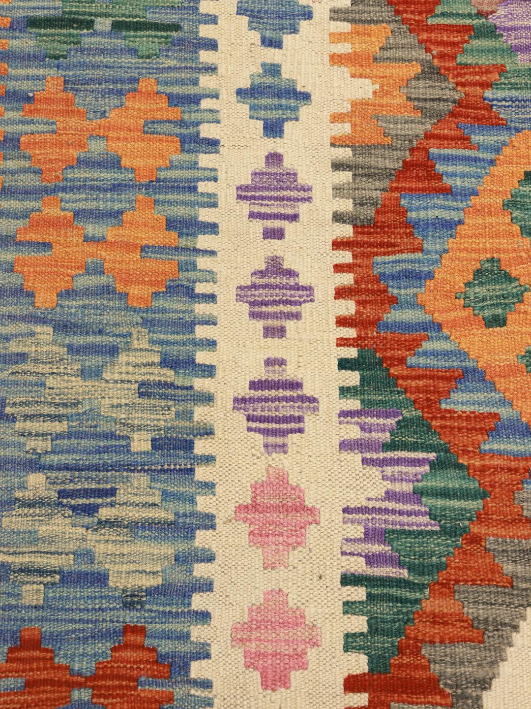 A large hand-woven Afghan Kelim rug featuring vibrant geometric diamond patterns in multicolour Wool.