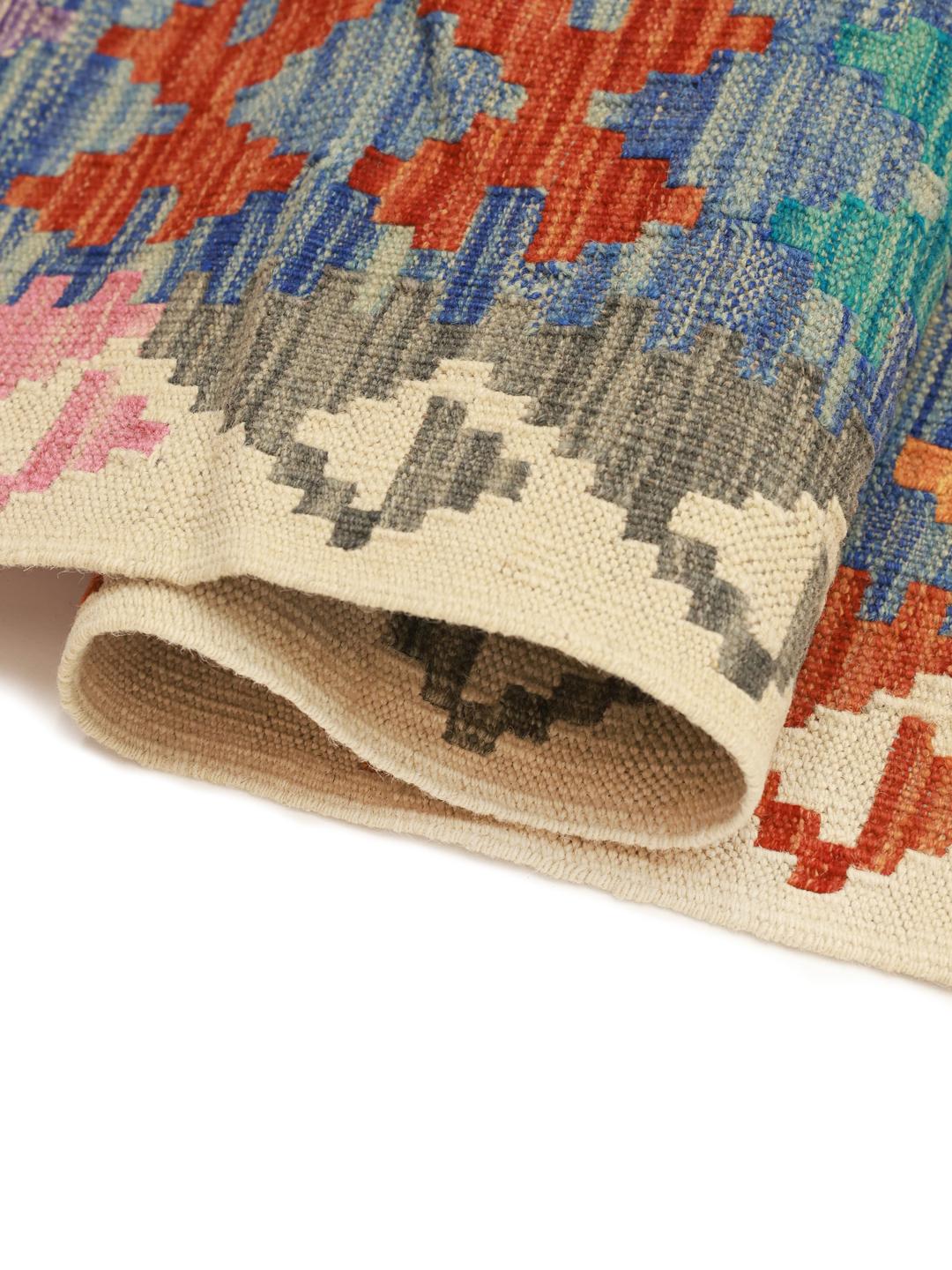 A large hand-woven Afghan Kelim rug featuring vibrant geometric diamond patterns in multicolour Wool.