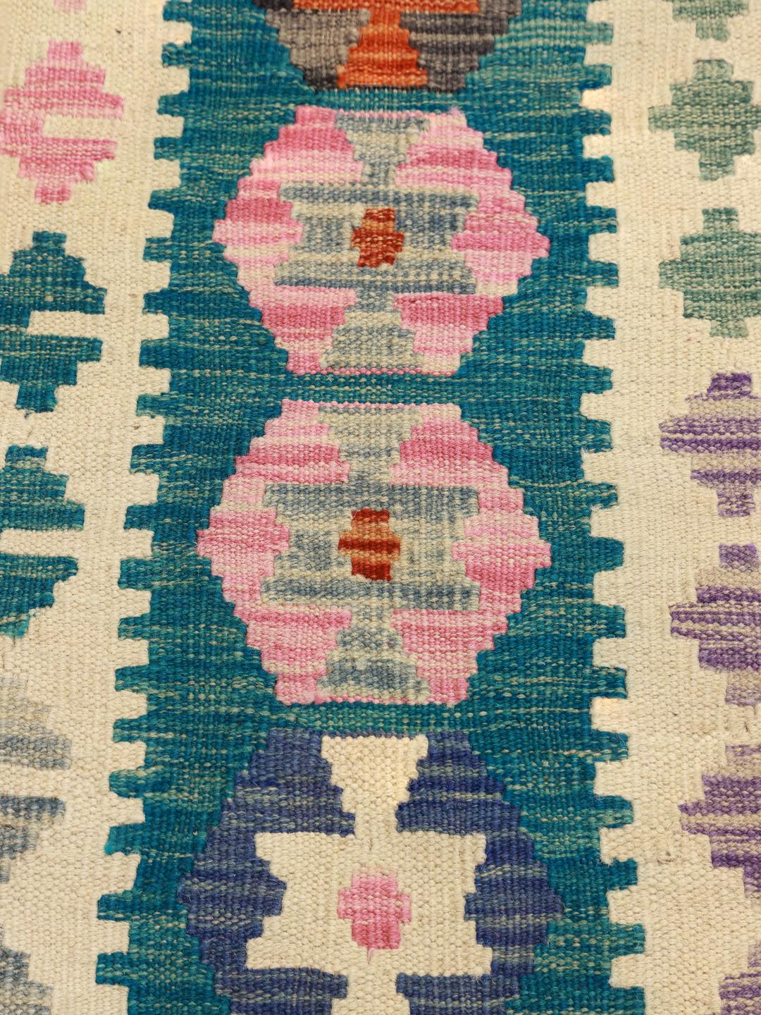 A large, rectangular Afghan Kelim rug featuring a vibrant geometric pattern in multicolor Wool.