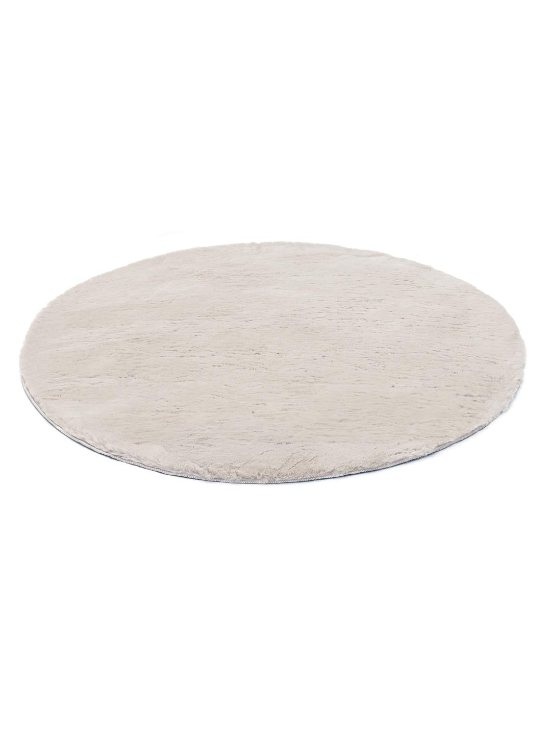 Rundt beige tæppe med en blød plystekstur