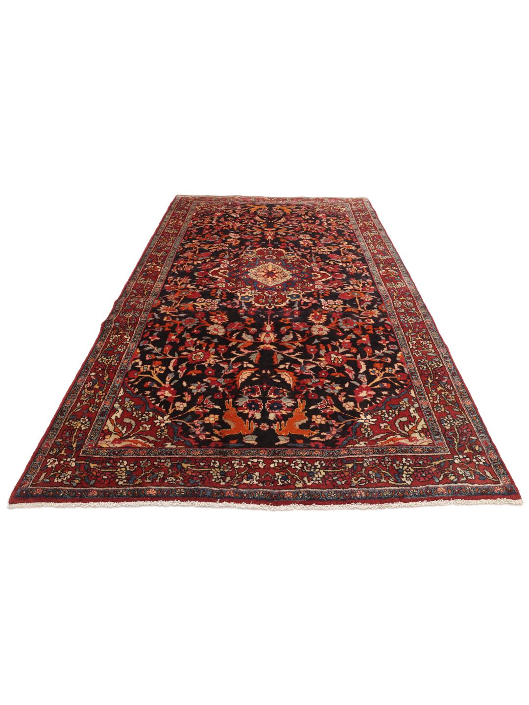 A hand-knotted Hamadan rug from the Middle East with a dark-red and black floral design.