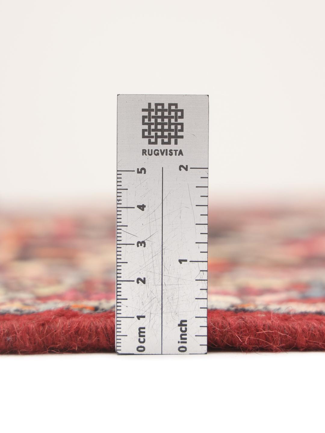 A hand-knotted Hamadan rug from the Middle East with a dark-red and black floral design.