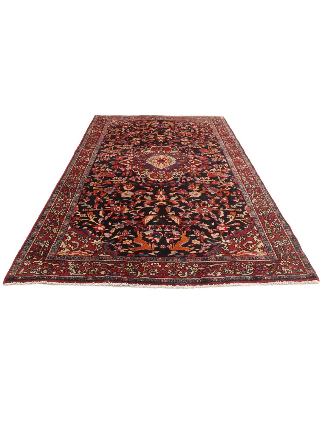 A hand-knotted Hamadan rug from the Middle East with a dark-blue and red floral design.