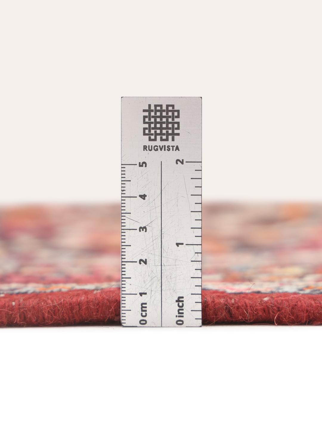 A hand-knotted Hamadan rug from the Middle East with a dark-blue and red floral design.