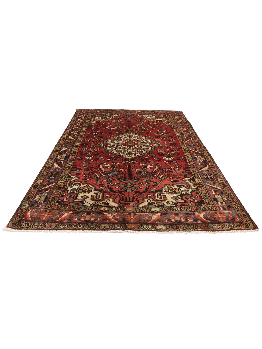 A hand-knotted Hamadan rug from the Middle East with a red field and medallion pattern.