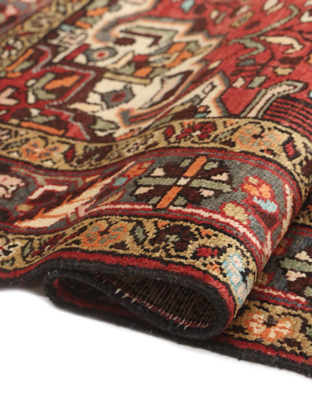 A hand-knotted Hamadan rug from the Middle East with a red field and medallion pattern.