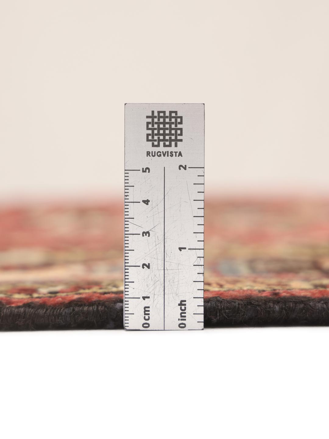 A hand-knotted Hamadan rug from the Middle East with a red field and medallion pattern.