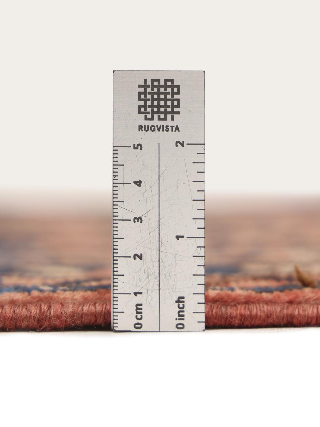 A hand-knotted Hosseinabad runner from the Middle East featuring a red and dark blue geometric pattern.
