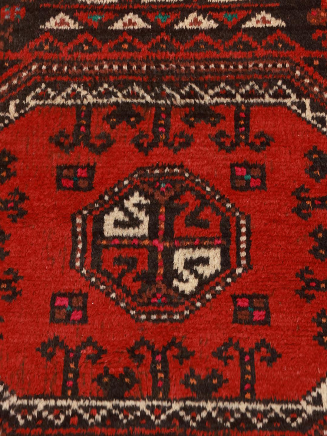 A hand-knotted Hamadan runner from the Middle East featuring a red field and traditional geometric motifs.
