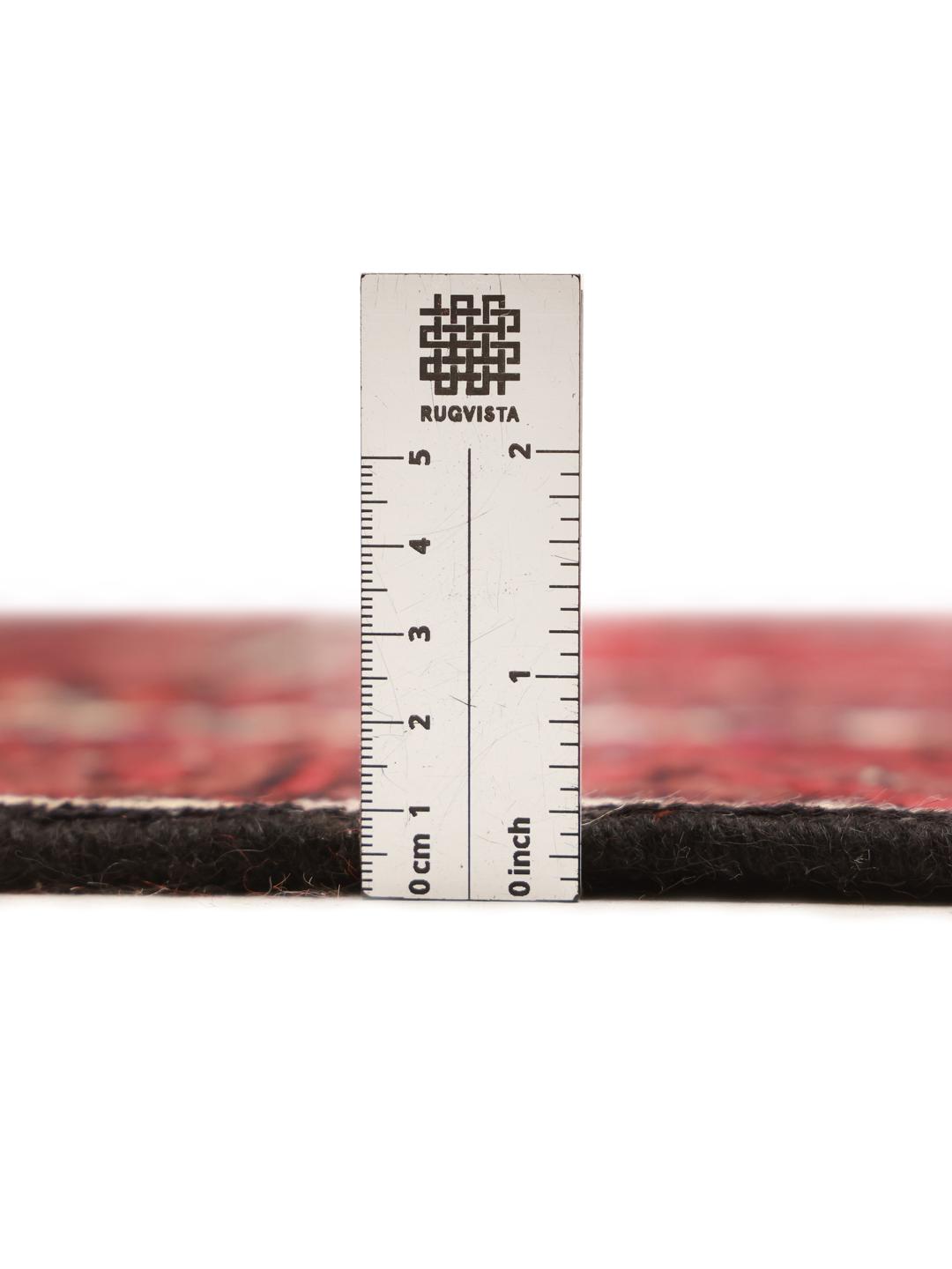 A hand-knotted Hamadan runner from the Middle East featuring a red field and traditional geometric motifs.